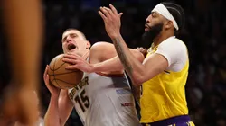Nikola Jokic #15 of the Denver Nuggets is fouled by Anthony Davis #3 of the Los Angeles Lakers
