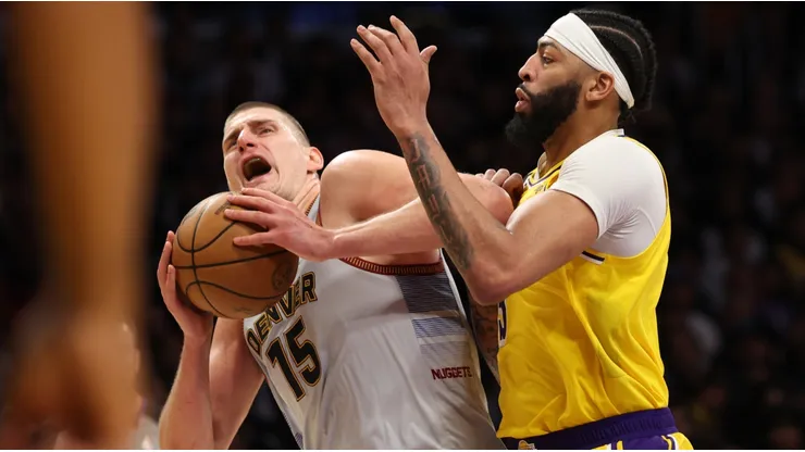 Nikola Jokic #15 of the Denver Nuggets is fouled by Anthony Davis #3 of the Los Angeles Lakers