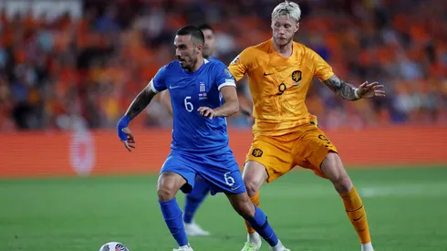 Dimitris Kourbelis of Greece is challenged by Wout Weghorst of Netherlands