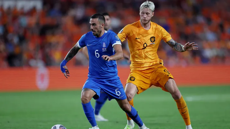 Dimitris Kourbelis of Greece is challenged by Wout Weghorst of Netherlands