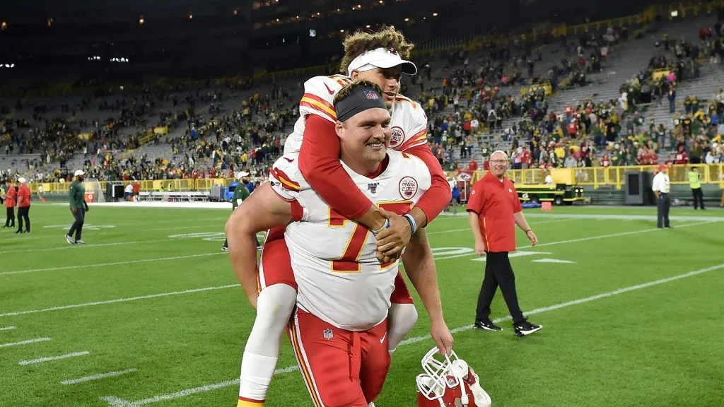 Patrick Mahomes is escorted off the field on the back of Andrew Wylie after a preseason game against the Green Bay Packers at Lambeau Field on August 29, 2019 in Green Bay, Wisconsin.