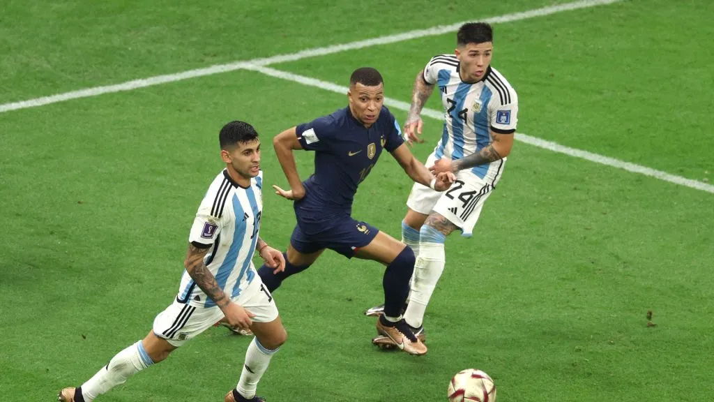 Kylian Mbappe of France competes for the ball against Cristian Romero and Enzo Fernandez of Argentina during the FIFA World Cup Qatar 2022 Final.