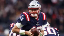 Mac Jones of the New England Patriots looks to hand the ball off.