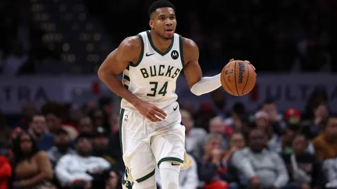 Giannis Antetokounmpo dribbling the basketball.