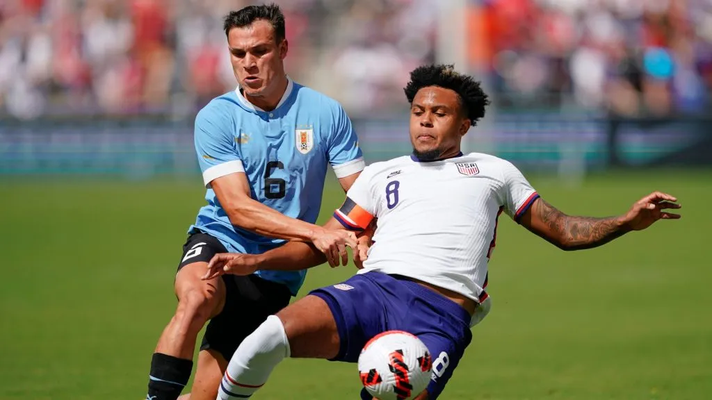 Manuel Ugarte #6 of Uruguay has the ball knocked away by Weston McKennie #8 of USA during the first half of the friendly matchat Childrenās Mercy Park on June 05, 2022 in Kansas City, Kansas.