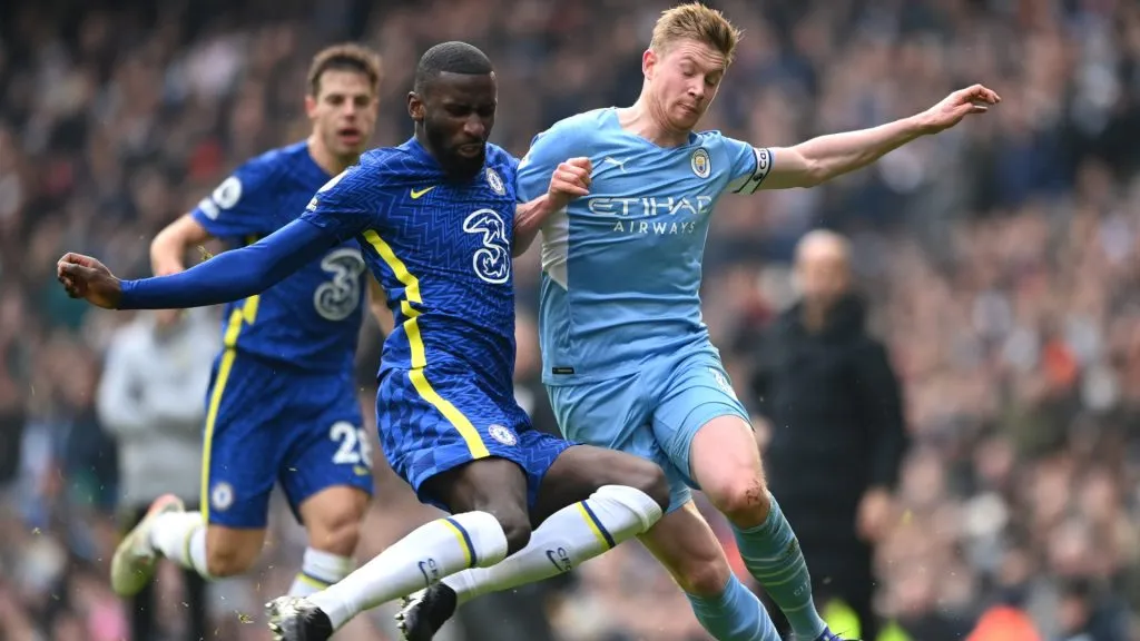Antonio Ruediger of Chelsea tackles Kevin De Bruyne of Manchester City during the Premier League match between Manchester City and Chelsea at Etihad Stadium on January 15, 2022 in Manchester, England.