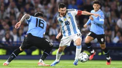Lionel Messi trying to dribble past Mathias Olivera