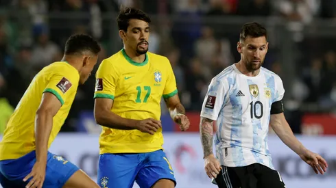 Lionel Messi competes for the ball with Lucas Paquetá (C) and Danilo da Silva (L) during a match in 2021.