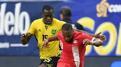 David Junior Hoilett of Canada battles for possession of the ball with Je-Vaughn Watson of Jamaica.
