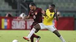 Jose Martinez of Venezuela and Moises Caicedo of Ecuador fight for the ball during a match in 2021.