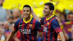 Alexis Sanchez celebrates with Lionel Messi at Barcelona.
