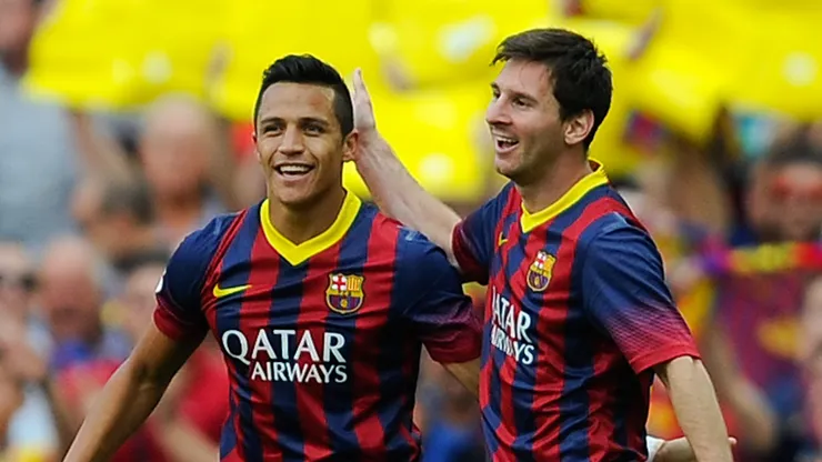 Alexis Sanchez celebrates with Lionel Messi at Barcelona.