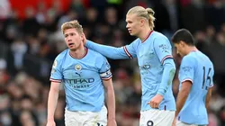 Kevin De Bruyne of Manchester City looks dejected while being consoled by teammate Erling Haaland after Bruno Fernandes of Manchester United scores the team's first goal during the Premier League match between Manchester United and Manchester City at Old Trafford on January 14, 2023 in Manchester, England.