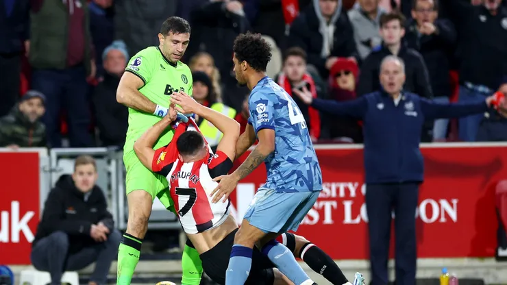 Emiliano Martinez and Boubacar Kamara of Aston Villa clash with Neal Maupay of Brentford during the Premier League match between Brentford FC and Aston Villa at Gtech Community Stadium on December 17, 2023 in Brentford, England.