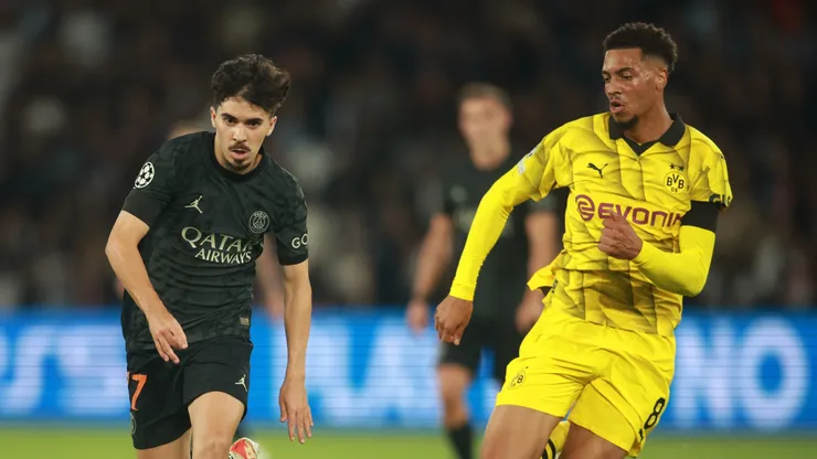 Vitinha (L) of Paris Saint-Germain under pressure by Felix Nmecha of Dortmund during the UEFA Champions League Group F match between Paris Saint-Germain and Borussia Dortmund at Parc des Princes on September 19, 2023 in Paris, France.