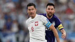 Robert Lewandowski under pressure from Lionel Messi during the FIFA World Cup Qatar 2022 Group C match between Poland and Argentina.