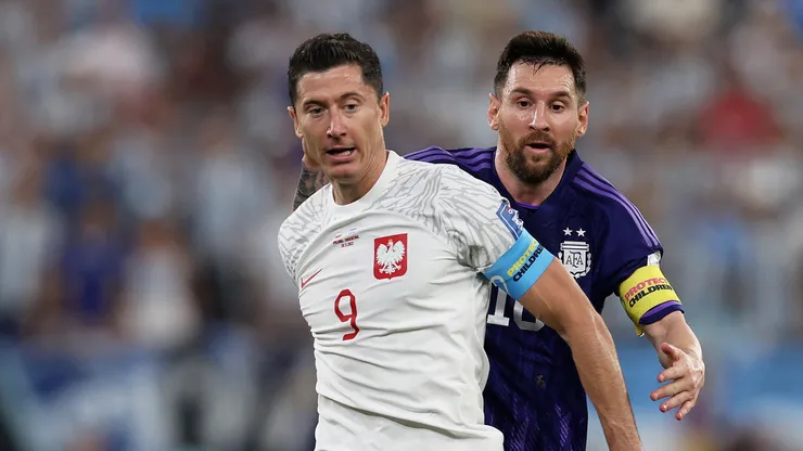 Robert Lewandowski under pressure from Lionel Messi during the FIFA World Cup Qatar 2022 Group C match between Poland and Argentina.