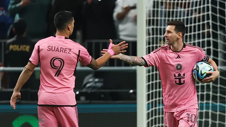 Lionel Messi and Luis Suarez celebrate.