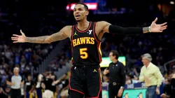 Dejounte Murray of the Atlanta Hawks complains to the referees.