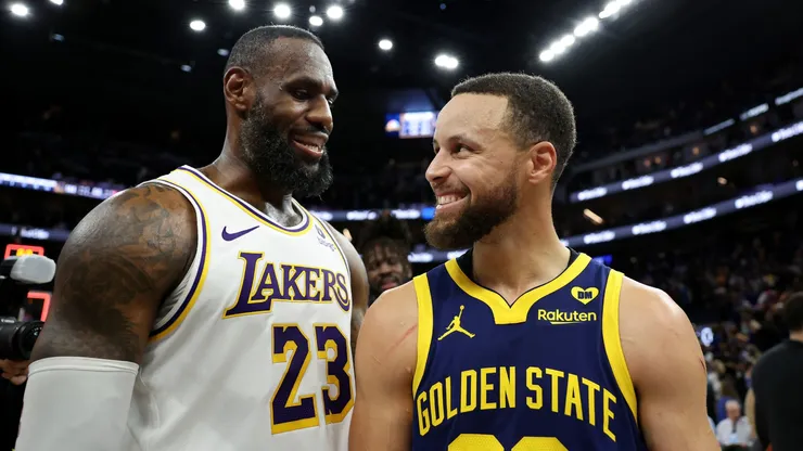 LeBron James (left) and Stephen Curry laughing after a game.