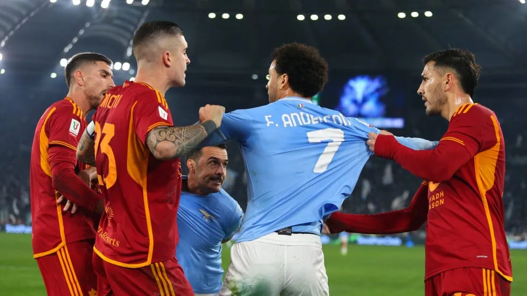 Felipe Anderson of SS Lazio is held back by Gianluca Mancini of AS Roma and Leandro Paredes of AS Roma during the Coppa Italia match between SS Lazio and AS Roma at Stadio Olimpico on January 10, 2024 in Rome, Italy.