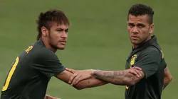Dani Alves (R) helps Neymar of Brazil stretch during a Brazil training session ahead of the 2014 FIFA World Cup Brazil opening match against Croatia at Arena de Sao Paulo on June 11, 2014 in Sao Paulo, Brazil.