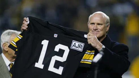 Retired Quarterback Terry Bradshaw of the Pittsburgh Steelers holds up his old number during the NFL game against the Indianapolis Colts at Heinz Field on October 21, 2002 in Pittsburgh, Pennsylvania. Pittsburgh won 28-10.
