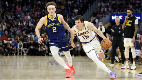 Austin Reaves #15 of the Los Angeles Lakers is guarded by Brandin Podziemski #2 of the Golden State Warriors
