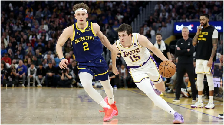 Austin Reaves #15 of the Los Angeles Lakers is guarded by Brandin Podziemski #2 of the Golden State Warriors