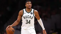 Giannis Antetokounmpo dribbling the basketball.