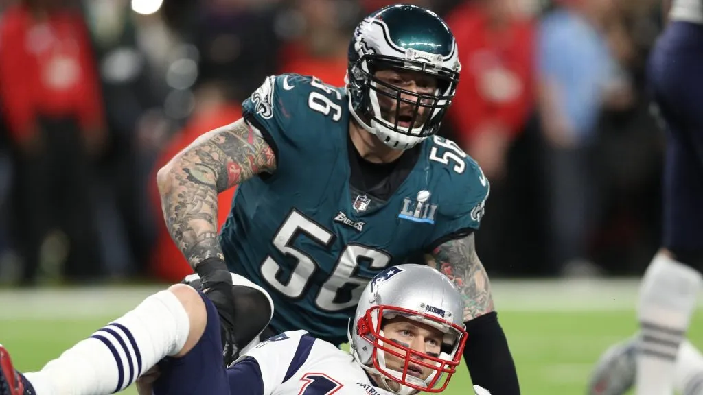 Tom Brady #12 of the New England Patriots is tackled by Chris Long #56 of the Philadelphia Eagles in the fourth quarter in Super Bowl LII at U.S. Bank Stadium on February 4, 2018 in Minneapolis, Minnesota.