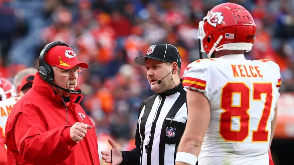 Kansas City Chiefs head coach Andy Reid speaks with Travis Kelce #87 during the second half against the Denver Broncos at Empower Field At Mile High on January 08, 2022 in Denver, Colorado.