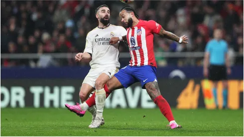 Memphis Depay of Atletico Madrid and Daniel Carvajal of Real Madrid