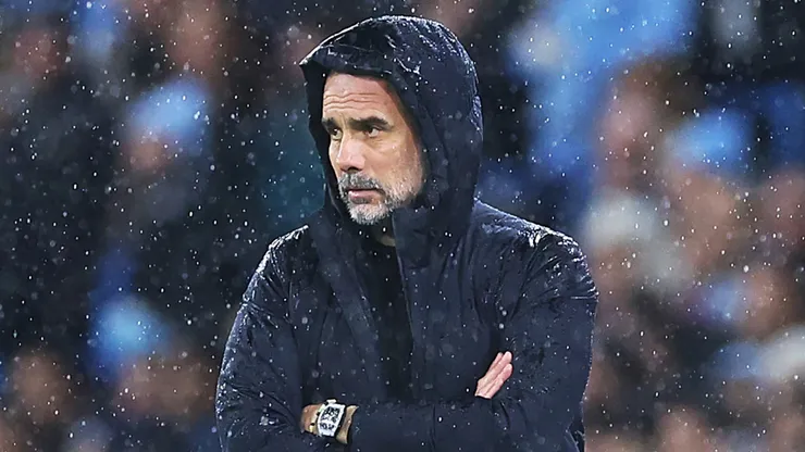 Man City coach Pep Guardiola looks on during a game.