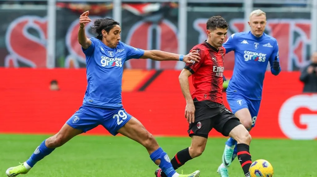 Christian Pulisic of AC Milan (R) and Youssef Maleh of Empoli FC (L) seen in action during Serie A 2023/24 football match between AC Milan and Empoli FC at San Siro Stadium.