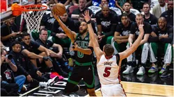 The Boston Celtics Jayson Tatum (0) lays up the ball while defended by the Miami Heat's Nikola Jovic