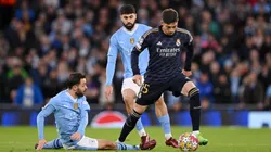 Federico Valverde of Real Madrid is challenged by Bernardo Silva of Manchester City during the UEFA Champions League quarter-final second leg match between Manchester City and Real Madrid CF at Etihad Stadium on April 17, 2024 in Manchester, England.
