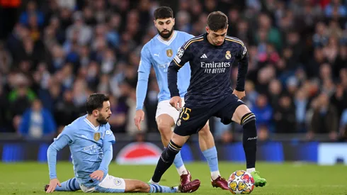 Federico Valverde of Real Madrid is challenged by Bernardo Silva of Manchester City during the UEFA Champions League quarter-final second leg match between Manchester City and Real Madrid CF at Etihad Stadium on April 17, 2024 in Manchester, England.