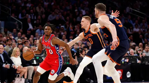 Tyrese Maxey #0 of the Philadelphia 76ers dribbles as Donte DiVincenzo #0 and Isaiah Hartenstein #55 of the New York Knicks defend during the first half in Game Two of the Eastern Conference First Round Playoffs at Madison Square Garden on April 22, 2024 in New York City.