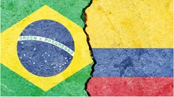 The Brazil and Colombia flags on a cracked wall