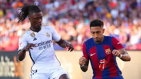 Raphinha of FC Barcelona is tackled by Eduardo Camavinga of Real Madrid during the LaLiga EA Sports match between FC Barcelona and Real Madrid CF at Estadi Olimpic Lluis Companys on October 28, 2023 in Barcelona, Spain.