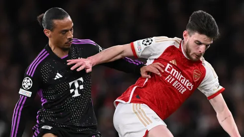 Declan Rice of Arsenal holds off Leroy Sane of Bayern Munich during the UEFA Champions League quarter-final first leg match between Arsenal FC and FC Bayern München at Emirates Stadium on April 09, 2024 in London, England.