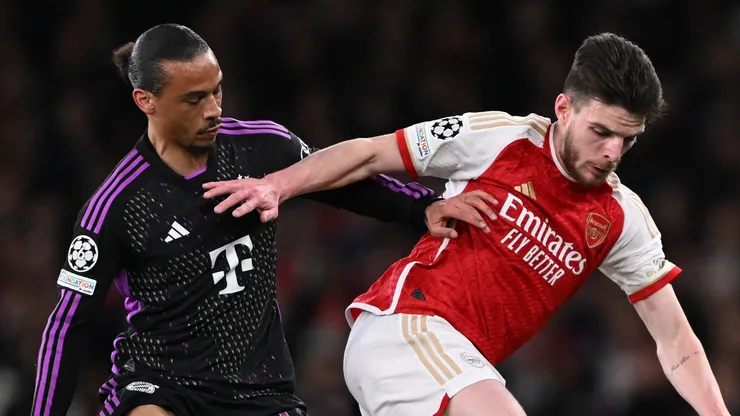 Declan Rice of Arsenal holds off Leroy Sane of Bayern Munich during the UEFA Champions League quarter-final first leg match between Arsenal FC and FC Bayern München at Emirates Stadium on April 09, 2024 in London, England.