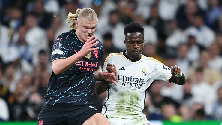 Vinicius Jr. of Real Madrid CF competes for the ball with Erling Haaland of Manchester City during the UEFA Champions League quarter-final first leg match between Real Madrid CF and Manchester City at Estadio Santiago Bernabeu on April 09, 2024 in Madrid, Spain.