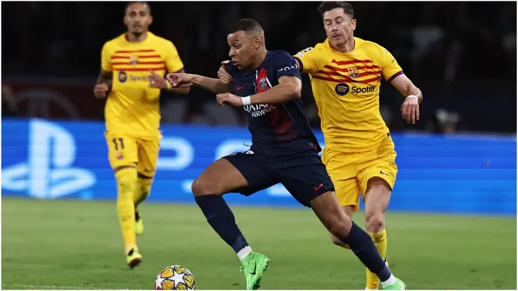Paris Saint-Germain's Kylian Mbappe vies with FC Barcelona's Robert Lewandowski