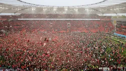 Fans of Bayer 04 Leverkusen invade the pitch after their team's victory and winning the Bundesliga title for the first time in their history