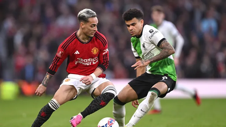 Antony of Manchester United is challenged by Luis Diaz of Liverpool during the Emirates FA Cup Quarter Final match between Manchester United and Liverpool at Old Trafford on March 17, 2024 in Manchester, England.