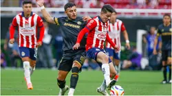 Alexis Vega (L) of Toluca fights for the ball with Pavel Perez (R) of Guadalajara