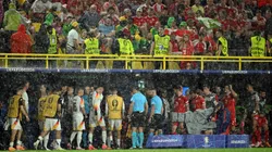 Players of Germany take shelter as play is suspended due to a thunderstorm during the UEFA EURO 2024 round of 16 match between Germany and Denmark at Football Stadium Dortmund on June 29, 2024 in Dortmund, Germany.