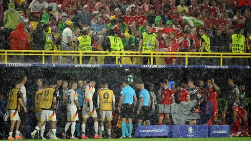 Players of Germany take shelter as play is suspended due to a thunderstorm during the UEFA EURO 2024 round of 16 match between Germany and Denmark at Football Stadium Dortmund on June 29, 2024 in Dortmund, Germany.